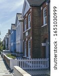 Small photo of London/UK-1/08/18: pastel-colored terraced houses on White Hart Lane in Barnes. Terrace house is a form of medium-density housing, whereby a row of attached dwellings share sidewalls