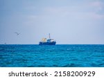 Fishing Boat In Blue Sea And...