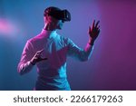 Small photo of VR guy play virtual battle game at meta verse and dive as digital character in cyber and fantasy world while live in a futuristic reality and create new digital identity