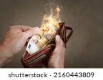 A burning 50 Euro bill in a wallet