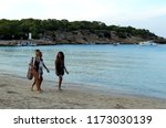 Small photo of Ibiza, Balear Islands, Spain; on August 23m 2018: Three women walking next to seashore on the famous and touristic beach of Ibiza island that is called Cala Bassa beach.