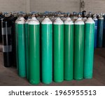 Many oxygen cylinders and argon cylinders with compressed gas secured in the Gas factory warehouse. Green Oxygen tanks for hospital. Black Oxygen tanks for industry. Blue argon tanks for industry.