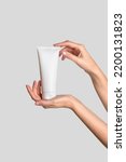 Small photo of Woman hand showing cream product. Cosmetic product branding mockup. Daily skincare and body care routine. Female hand holding cosmetic product mockup, close up.