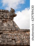 Small photo of A lizard sits on top of an antique statue of Kukulcan at Chichen Itza, Mayan Ruins, Yucatan, Mexico. detail at the Temple of High Priest.
