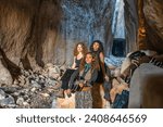 Small photo of Samandag, Antakya, Turkey- December 29, 2023: beautiful girls playing guitar in the Vespasianus Titus Tunnel, which is an ancient water tunnel built for the city of Seleucia Pieria, Antakya, Turkey