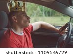 Small photo of Arrogant driver man with golden crown above his head. Disdainful and boorish attitude on the road concept.