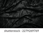 Camouflage pattern. Trendy dark gray camouflage fabric. Military texture. Dark background.