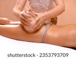 Vacuum Therapy for Buttocks. Woman using suction cup pump up on butt to lift it up