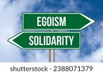 Small photo of Egoism or solidarity road sign on cloudy sky background