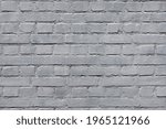 The bright texture of the old brick wall is completely painted with gray paint. A high resolution.