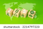 Small photo of Net-Zero Carbon Emissions by 2050. A Roadmap for the Global Energy Sector. Wooden cubes with text 2050 and green icons over the world map. Deployment of clean energy innovation. World earth day