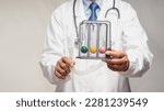 Small photo of A doctor holding an incentive spirometer to help perform deep breathing exercises while standing in the hospital. Helpful for pneumonia or a lung condition like chronic obstructive pulmonary disease