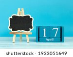 Small photo of wooden calendar with the date of april 17 and an easel on a blue background, place for text, World Malbec Day; World Hemophilia Day