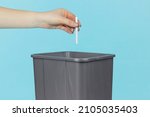 Small photo of throw a cigarette in the trash bin, cigarette in hand in front of the trash bin, smoking cessation concept
