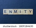 Small photo of gray word enmity from small wooden letters on a black table
