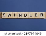 Small photo of gray word swindler from small wooden letters on a black table