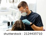 Small photo of the dentist examines the patient's oral cavity