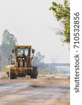 Small photo of Compaction machinery for rail road construction in Chiang Mai, Thailand. Grader is working on a road construction site to smooth the ground.