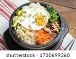 Korean bibimbap rice dish topped with a fried egg