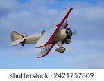 Small photo of old Warden, UK - 2nd October 2022: Vintage aircraft Curtiss wright travel air 4000 flies close to the ground