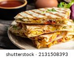 Small photo of Mexican tortilla quesadilla with scramble eggs, vegetables, ham and cheese, Mexican cuisine, Mexico and Latin America traditional restaurant menu dish, food cooking recipe book cover.