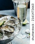 Small photo of Fresh oysters with lemon and ice. Restaurant delicacy. oysters dish. Oyster dinner with champagne in restaurant. menu, dieting, cookbook recipe.