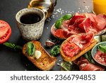 Traditional Spanish breakfast. Tostada with Jamon Iberico ham and tomatoes, olive oil bread with coffee. banner, menu, recipe place for text, top view.