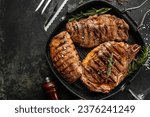 three beef steaks with grilled spices on a stone background. Restaurant menu, dieting, cookbook recipe top view
