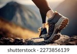 Athletic pair of female legs in running shoes on trail. Young attractive woman walking or hiking in forest or park, preparing for sprint or marathon.