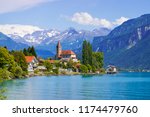 Panoramic view to the Brienz town on lake Brienz by Interlaken, Switzerland. Old fishing town with beautiful church and snow covered Alps mountains on background. Switzerland, Europe.