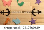 Small photo of Unscramble the words written on a wooden surface. Economy and markets
