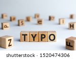 Small photo of Typo - word from wooden blocks with letters, a typographical error typo concept, random letters around, white background