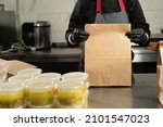 Small photo of close-up, volunteers packing free hot lunches in the Poor Lunch Boxes. Food delivery. Charitable project, charitable assistance. copy space.