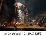 Small photo of Varanasi , India - 8 December 2023, Main famous scene of Aarti of Banaras Ghat priest worshiping with oil lamp and incense sticks at dasaswamedh ghat in Varanasi Uttar Pradesh India