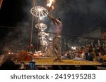 Small photo of Varanasi , India - 8 December 2023, Main famous scene of Aarti of Banaras Ghat priest worshiping with oil lamp and incense sticks at dasaswamedh ghat in Varanasi Uttar Pradesh India