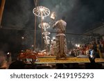 Small photo of Varanasi , India - 8 December 2023, Main famous scene of Aarti of Banaras Ghat priest worshiping with oil lamp and incense sticks at dasaswamedh ghat in Varanasi Uttar Pradesh India