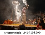 Small photo of Varanasi , India - 8 December 2023, Main famous scene of Aarti of Banaras Ghat priest worshiping with oil lamp and incense sticks at dasaswamedh ghat in Varanasi Uttar Pradesh India