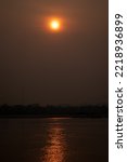 Small photo of The Sunrise environment at Mekong River, shoot image from Thailand side to Laos country with sunlight reflexion on surface river.