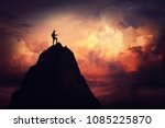 Self overcome concept as a businessman climbing a tall mountain over the clouds. Road to win and succes over sunset background. Achieving goals symbol.