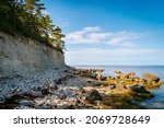 Small photo of Panga cliff in Saaremaa, Estonia during sunny day. The highest bedrock outcrop in western Estonia on coast of the Baltic sea