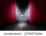 The red curtains are opening for the theater show