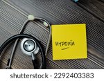 Small photo of Concept of Hypoxia write on sticky notes with stethoscope isolated on Wooden Table.