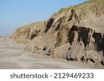 Small photo of Damaged dunes at the beach along the North Sea in Castricum, North Holland after storms Dudley, Eunice and Franklin in februar1 2022