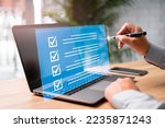 Small photo of Digital work checklist on virtual screen concept, Businessman use a pen point on checklist and use laptop working in office Document Management System and process automation to efficiently manage file