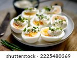 Small photo of Boiled egg halves with mayonnaise and green onions.