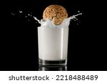 A glass of milk with sprinkles and an oatmeal cookie.