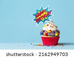 Celebration birthday cupcake with superhero happy birthday cake pick