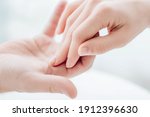 Two hands gently touching each other closeup. Holding hands. Love, skin care, tenderness, relationship, Valentine's day, hands cream, softness, tenderness concept.