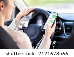 Small photo of Using phone while driving car. Distracted driver texting while in vehicle. Irresponsible woman checking sms message with mobile cellphone in traffic. Holding smartphone in hand. Auto accident concept.