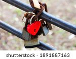 A Red Heart Shaped Lock As A...